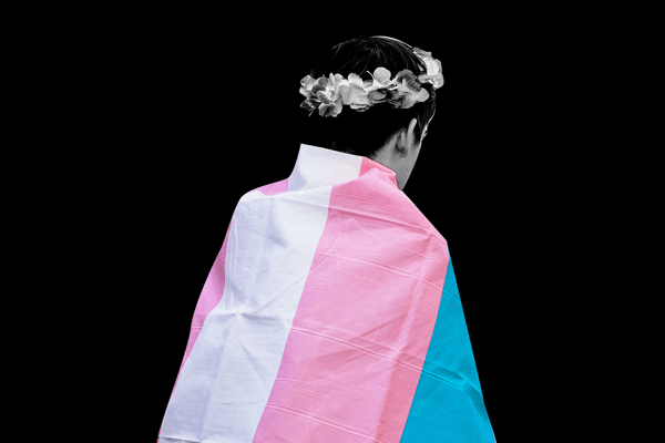 youth wearing a transgender flag