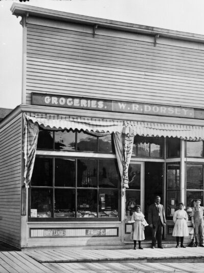 W.R. Dorsey Groceries-Hay-Grain 900 8th Avenue in Helena [Walter Dorsey with his 2 daughters in doorway] Photograph by Edward Reinig ca. 1899-1929 MHS Photo Archives, PAc 74-104.266 GP