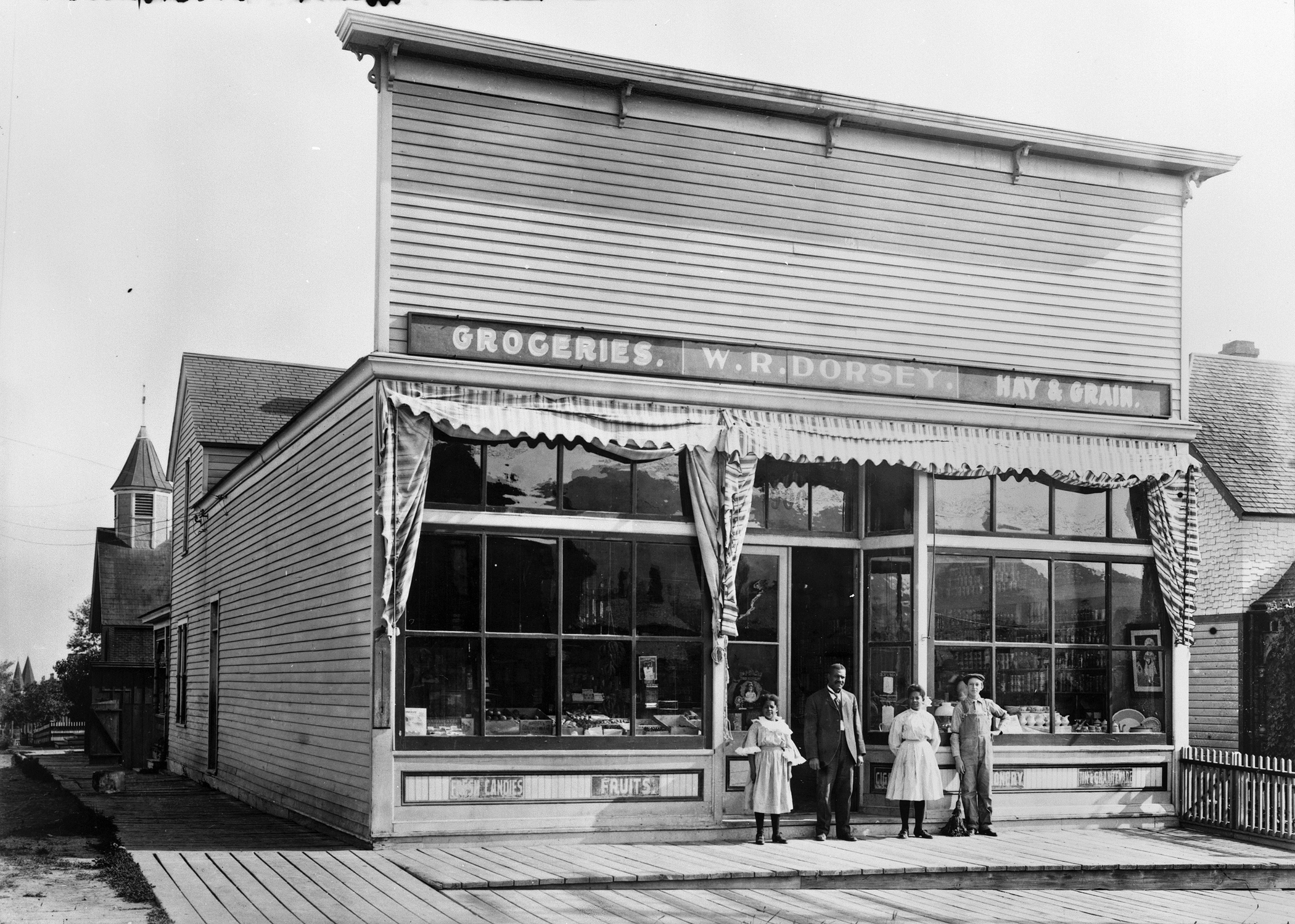 W.R. Dorsey Groceries-Hay-Grain 900 8th Avenue in Helena [Walter Dorsey with his 2 daughters in doorway] Photograph by Edward Reinig ca. 1899-1929 MHS Photo Archives, PAc 74-104.266 GP