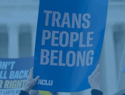 A photo of an ACLU protest sign reading TRANS PEOPLE BELONG