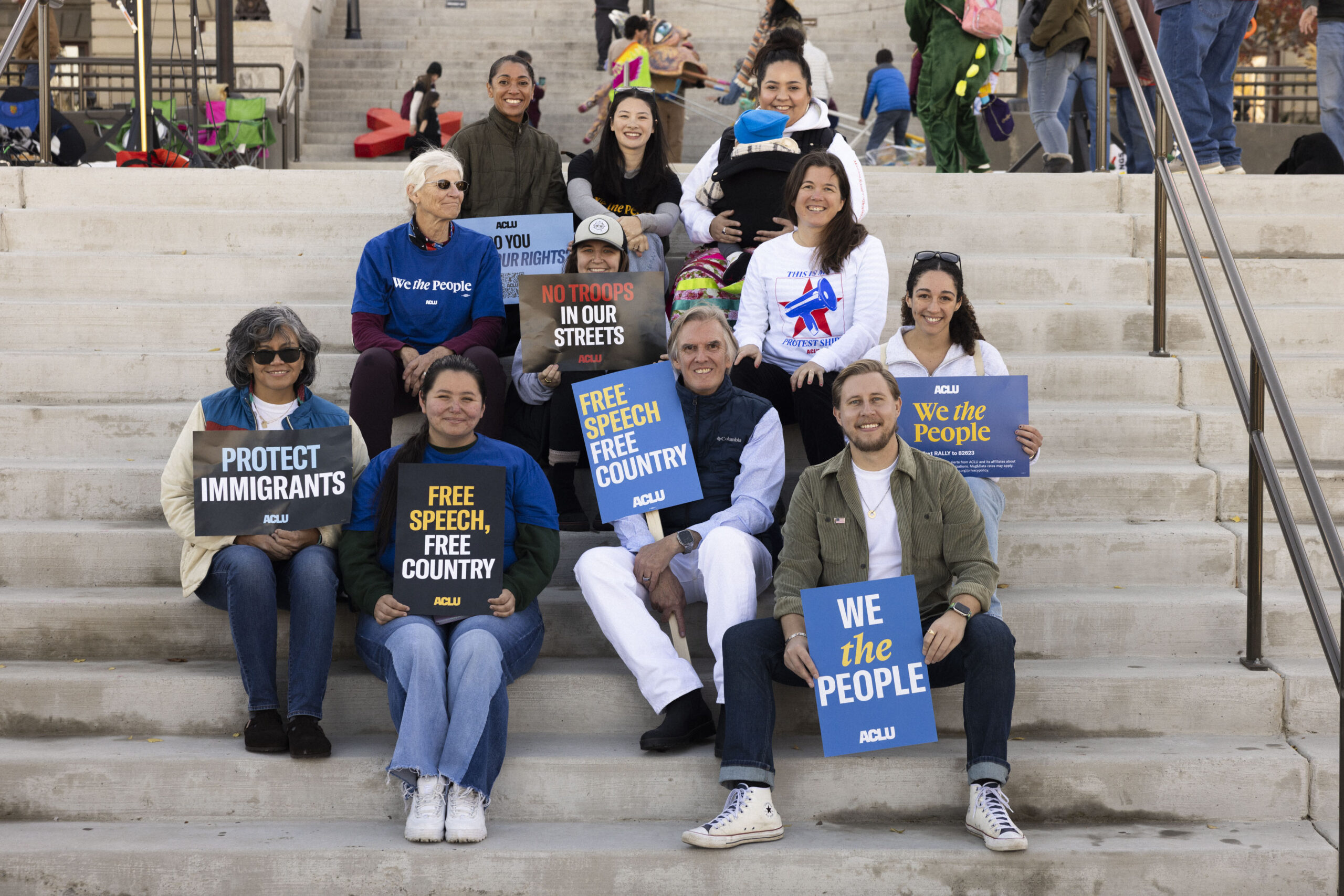 ACLU staff and supporters sitting on the steps of the Montana capitol