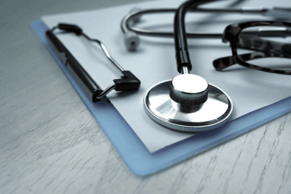 stethoscope lying on a clipboard