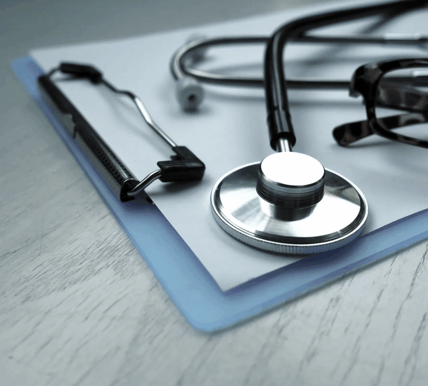 stethoscope lying on a clipboard
