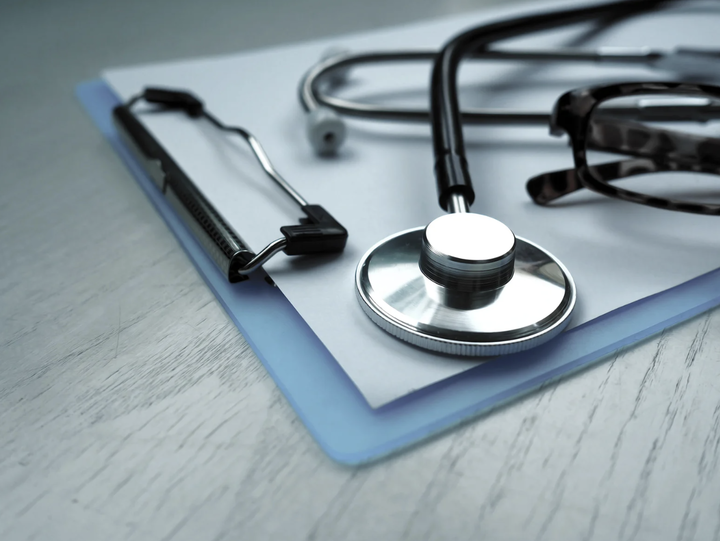 stethoscope lying on a clipboard
